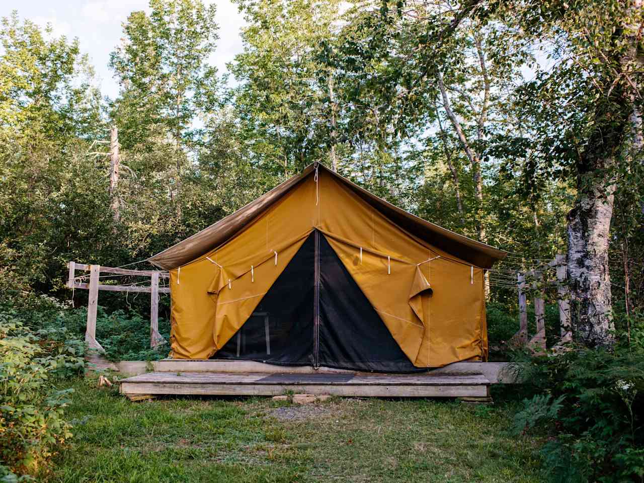 Wall-tent exterior, shown with canvas doors tied open and bug screen zipped shut