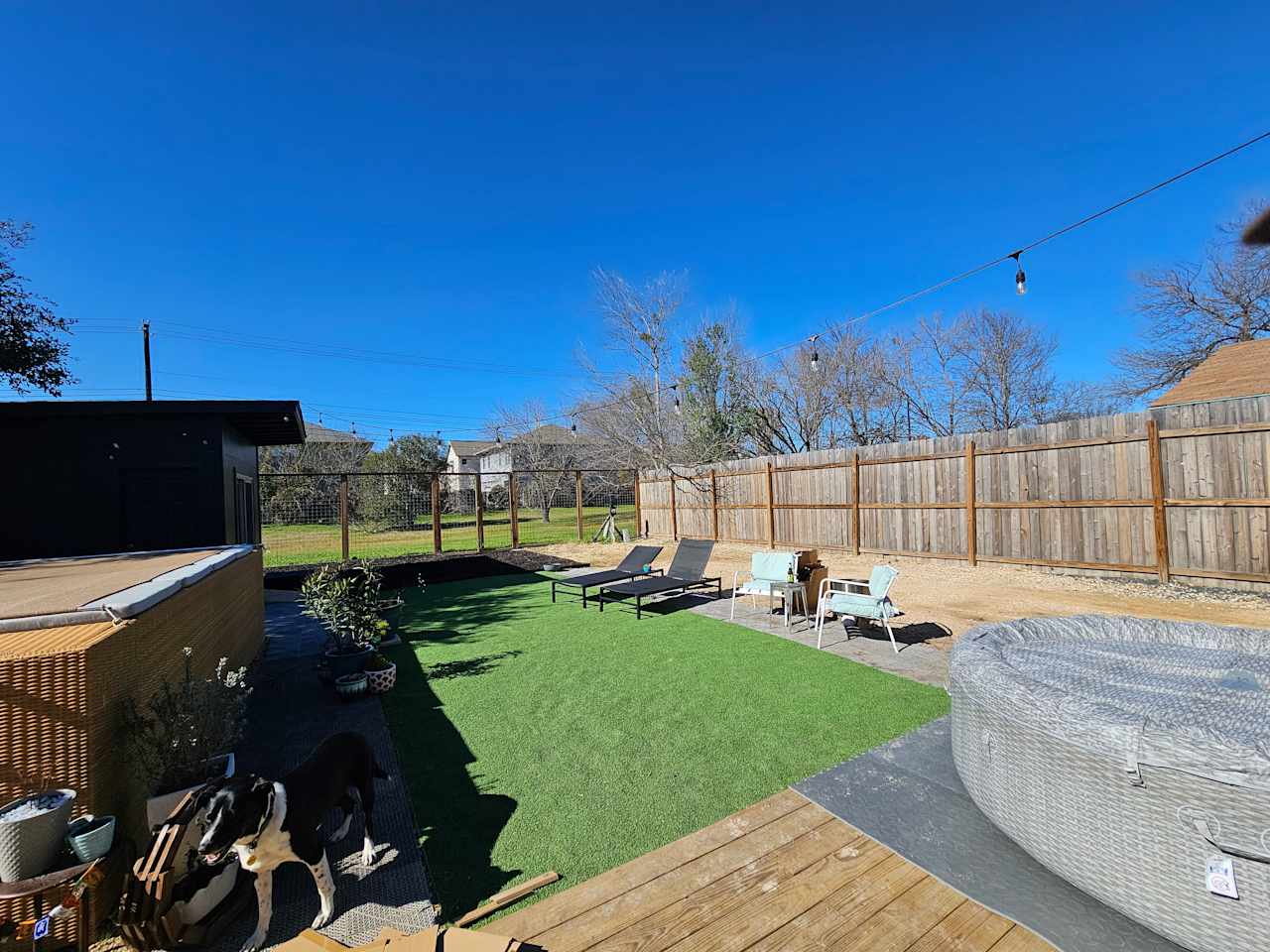 Slip on in...enjoy Austin...come to your home away from home! There's no "real" grass on the property. However, the gates in the back can be unlocked to enjoy a long and wide green space. Very large park and the river is less than a mile.