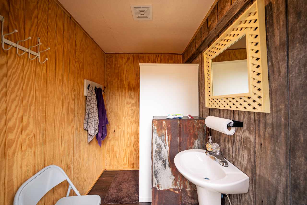 The shower room, nicely equipped with a sink and mirror!