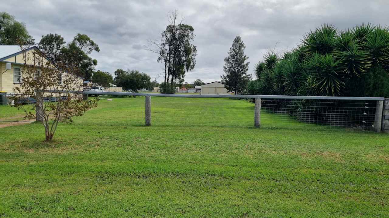 Front paddock and fence for private camping and communal fire pit.