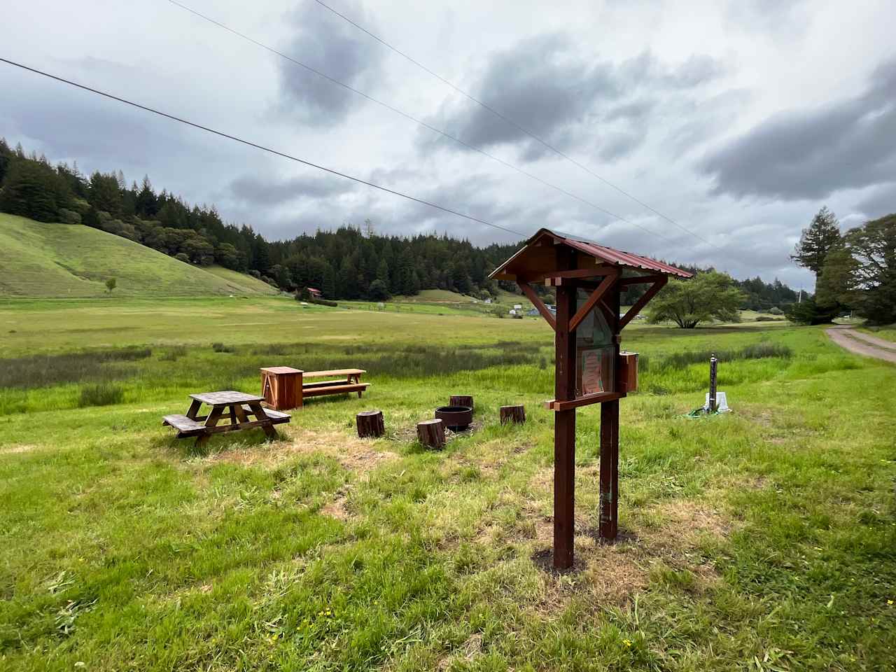 The communal area for the campground with our sign board, picnic tables, bear box and fire pit (fires only permitted Oct-May) 