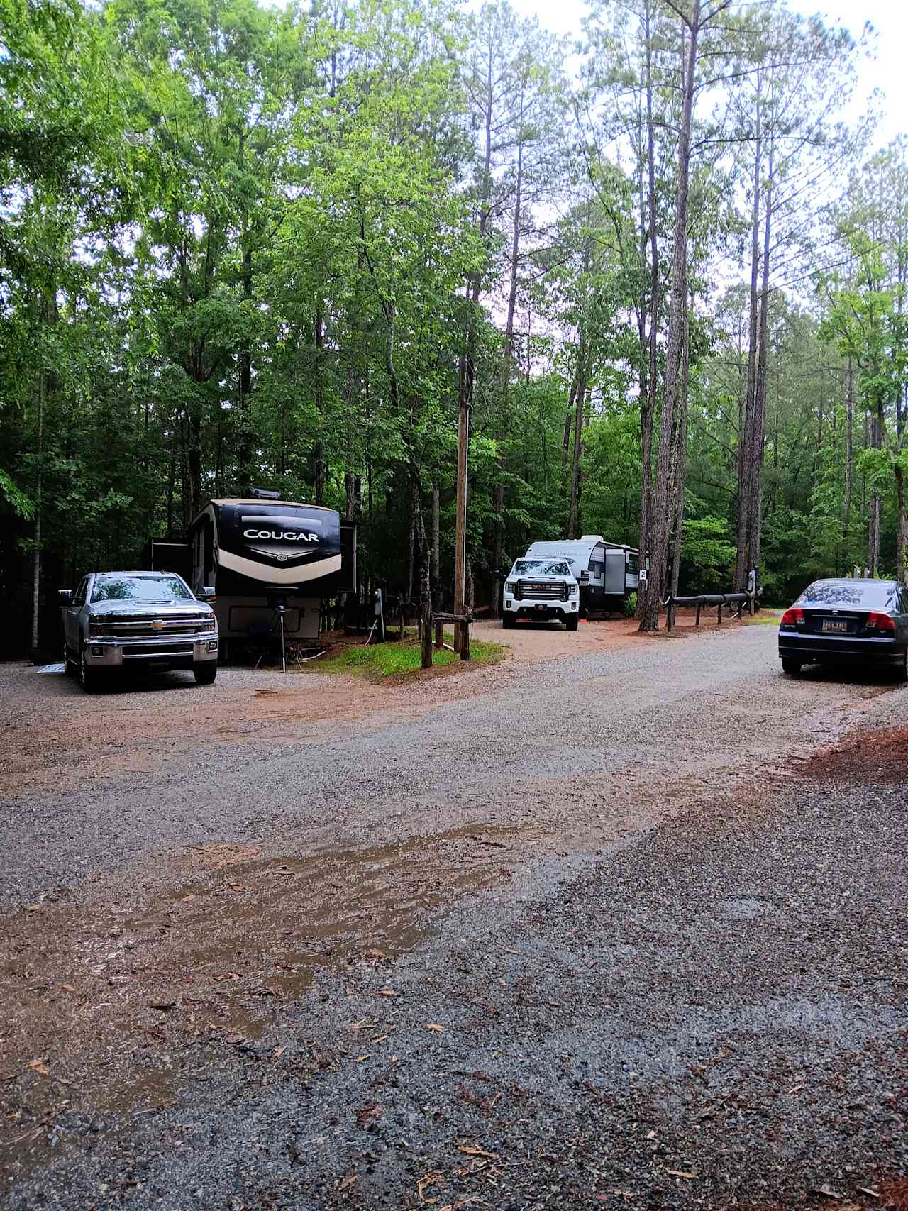 Pic on the right shows a 33ft pull type camper behind a crew-cab GMC with room to spare. I don't mind helping people back in. The slide outs were close to the tree and some rigs are better than others. Had a fifth wheel on this site. It was less than 40ft and didn't fit as well as a 30ft but still was room for the tow truck and a small car.