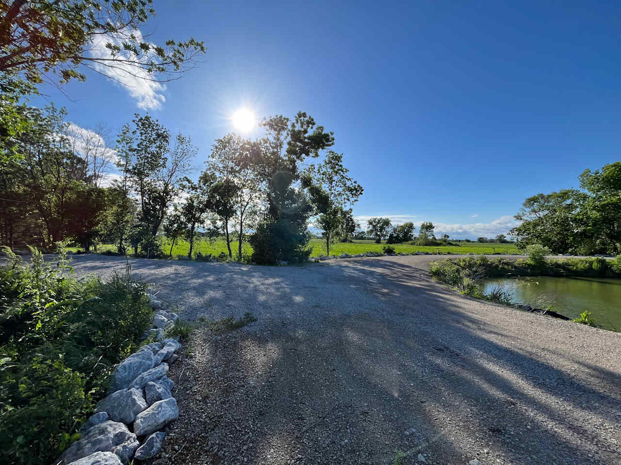 Site 1 - Picture taken in May. You can see this site has direct access to the pond. Please do not block the road. For RV campers - please do not block the road. There Is additional parking steps away from the site. Thanks!
