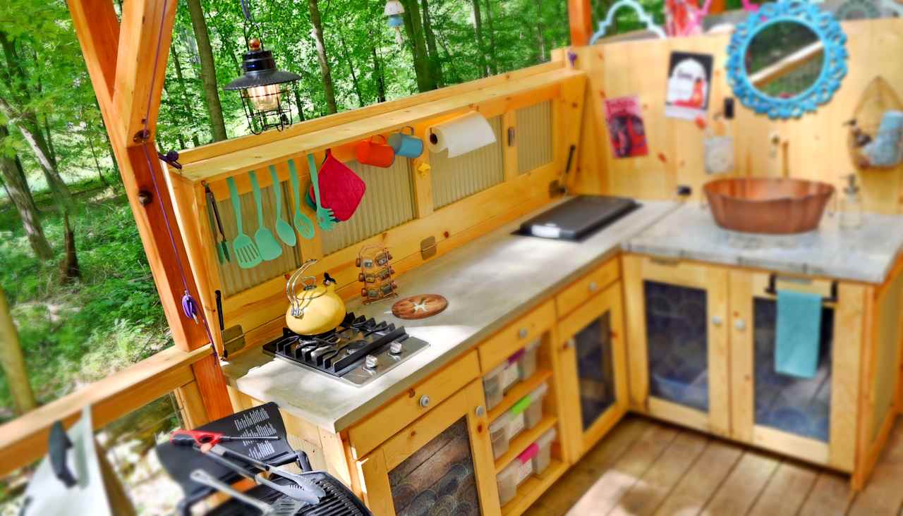 The Bombay Belle's outdoor kitchen is equipped with a 2-burner stove, a 42 qt. BougeRV fridge, everything needed to make outstanding outdoor meals.