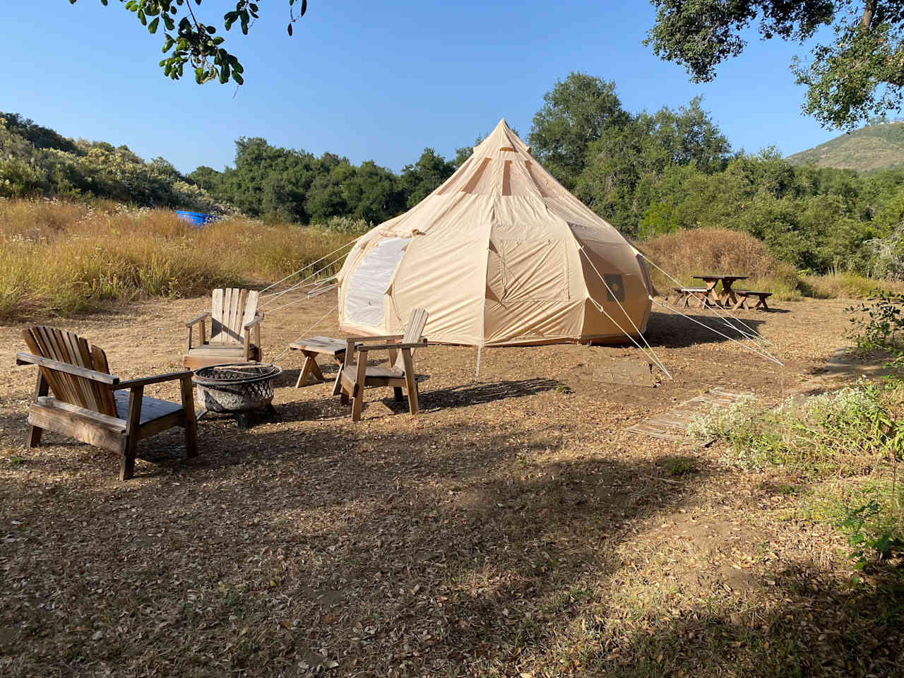 The site features a new Stargazer Lotus tent, a fire pit with chairs and a picnic table. Leave your tent at home, but bring your sleeping bags. 