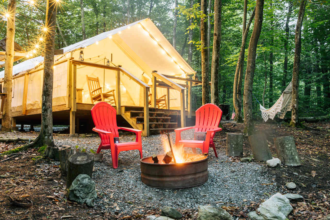 There is a firepit, chairs, and a lot of wood around that can be used for fires. 