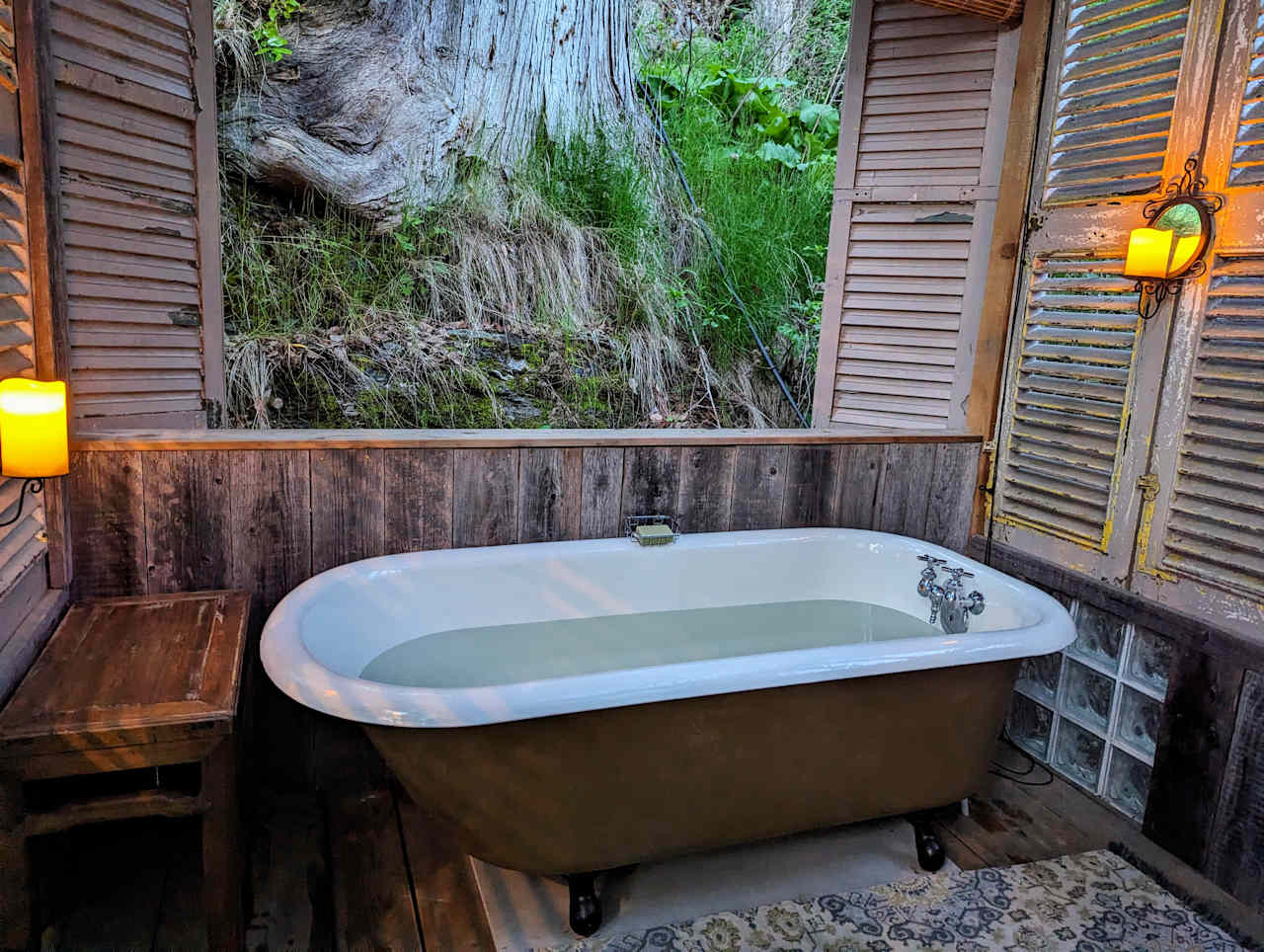 Soak in this this 100-year-old cast iron fully refurbished tub by candlelight beside a giant cedar.