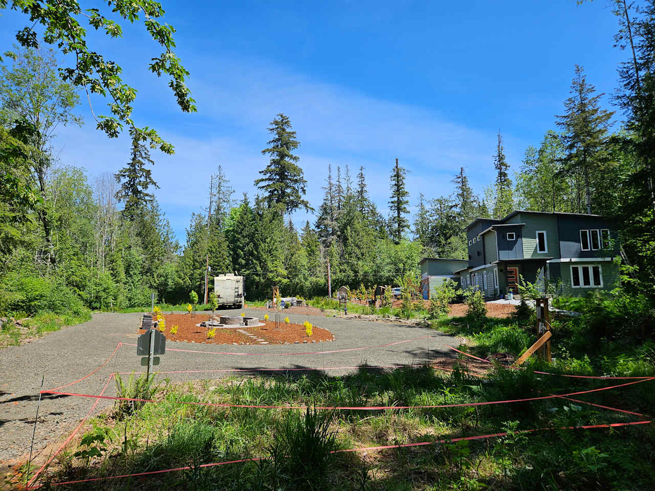 Driveway circle fire pit and RV site viewed from location of future 1-bed/1-bath cottage
