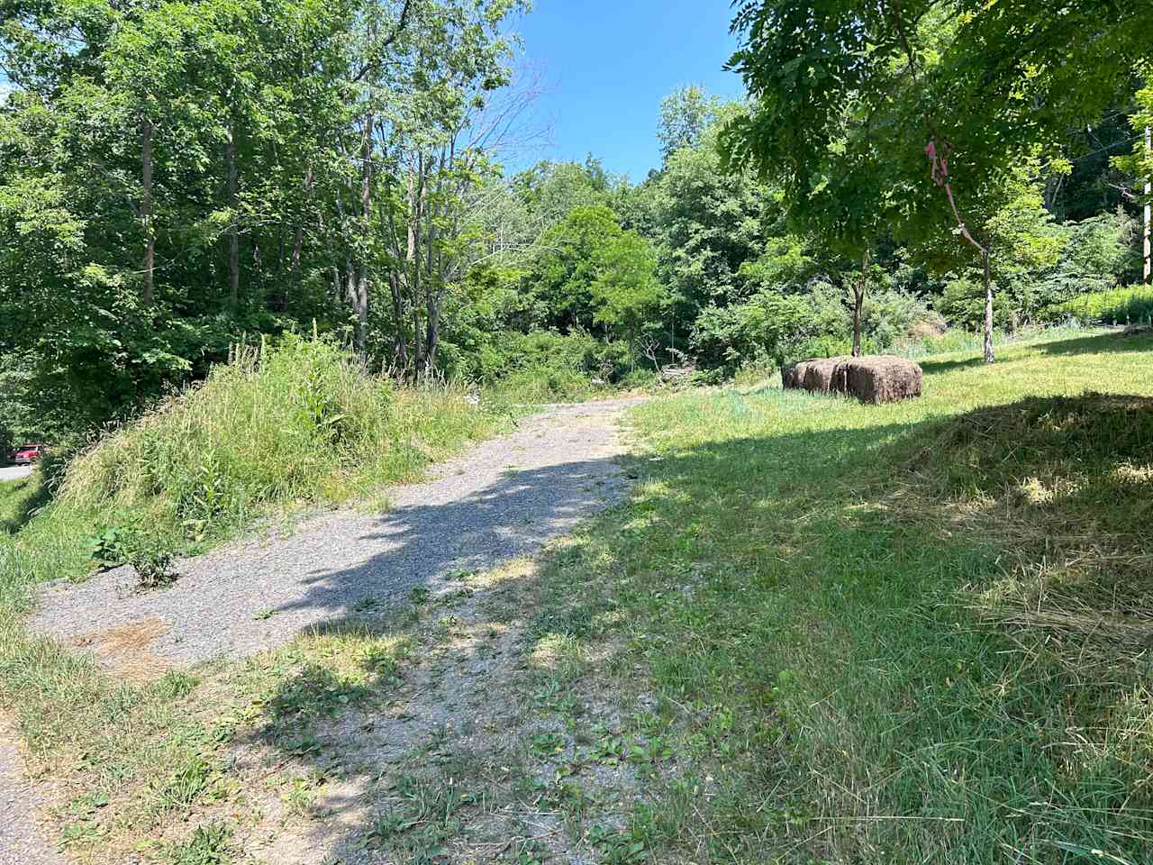 Entrance to campsites. Approach is gravel and goes into the graded parking lot at top left.  