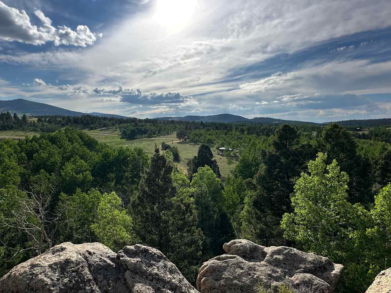 View of the cabin from a rocky vista. 