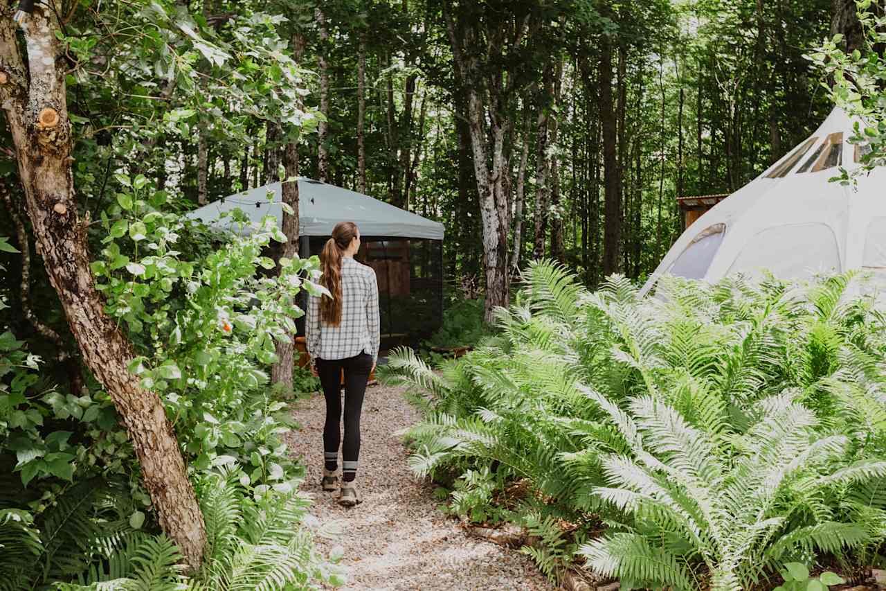 The site is well laid out with loose rock act the trail between the tent, dining tent, outhouse, and outdoor shower.