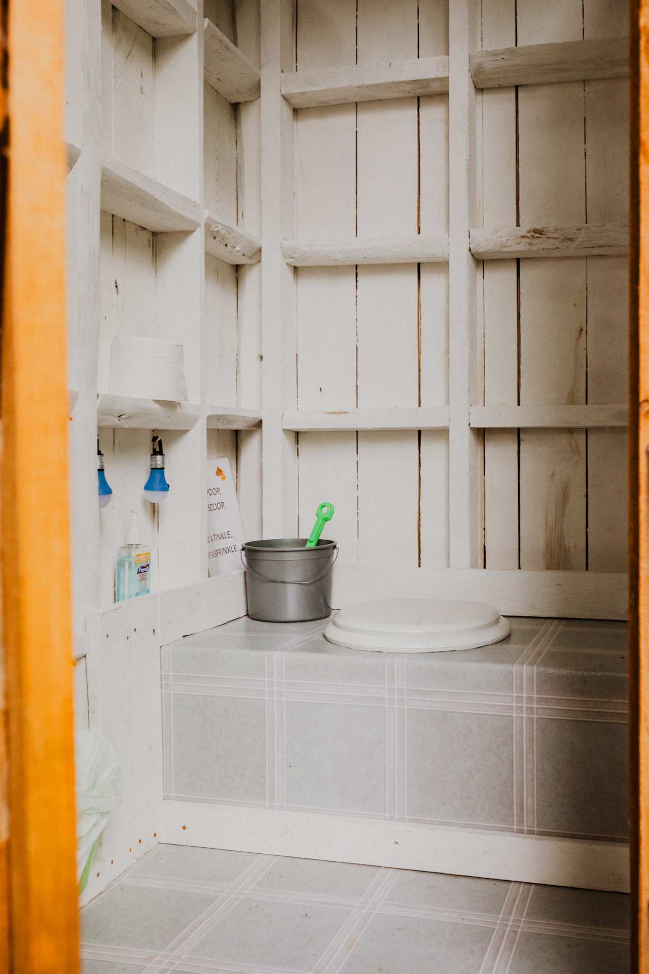 The outhouse is equipped with two flashlights for nighttime use. There is also sanitizer and a bucket with wood chips for keeping the smell down.