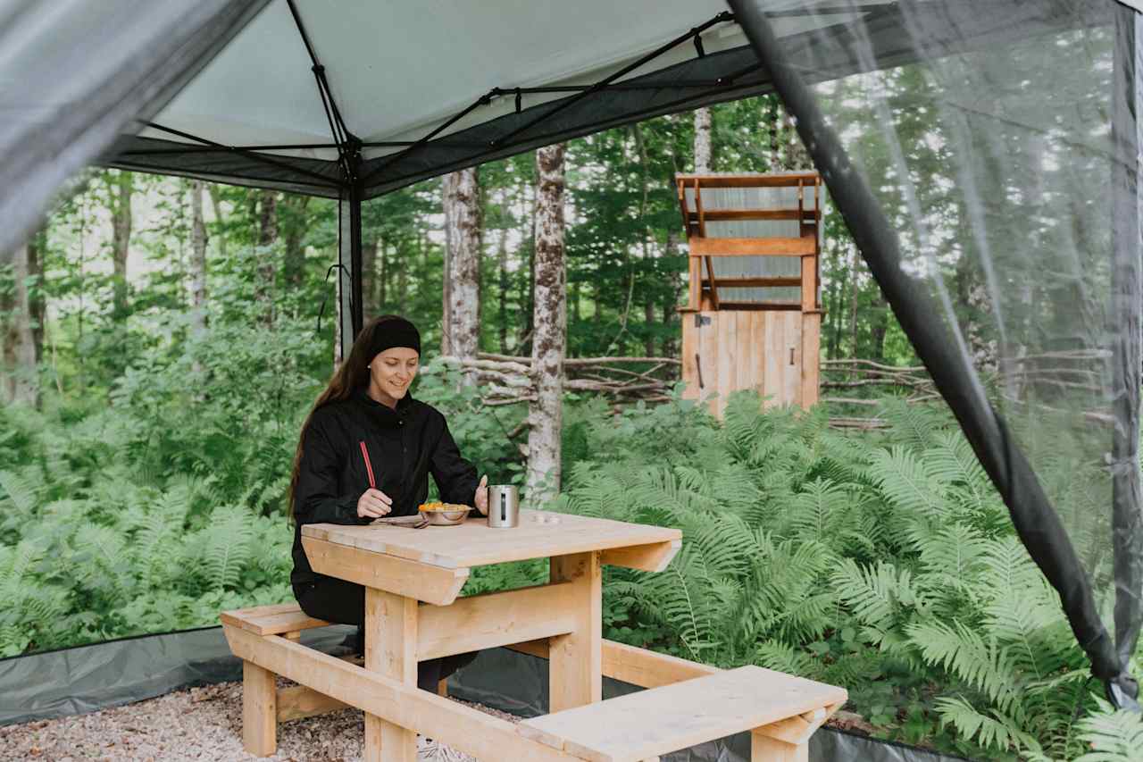 There is plenty of space inside the dining tent for eating. John built this beautiful bench!