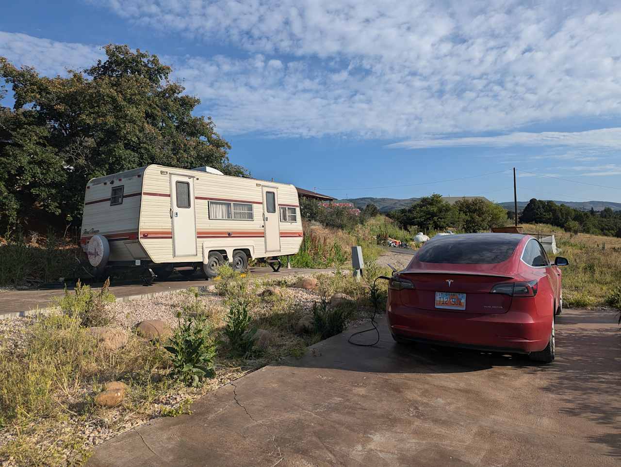 RV pad looking up the hill. The owners cabin can be seen just beyond the white trailer. 