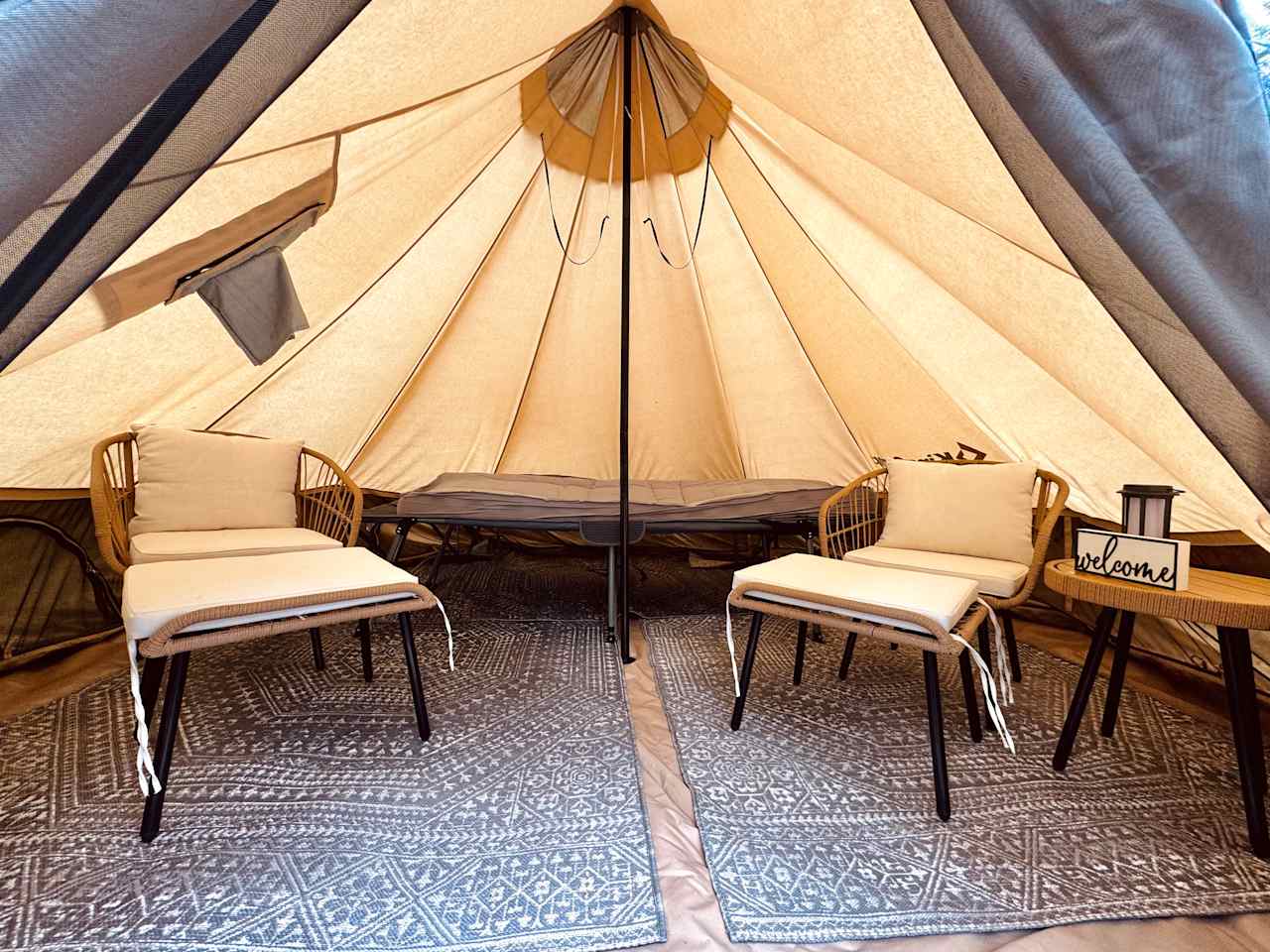 Inside provided tent - has chairs, table, cot with pad