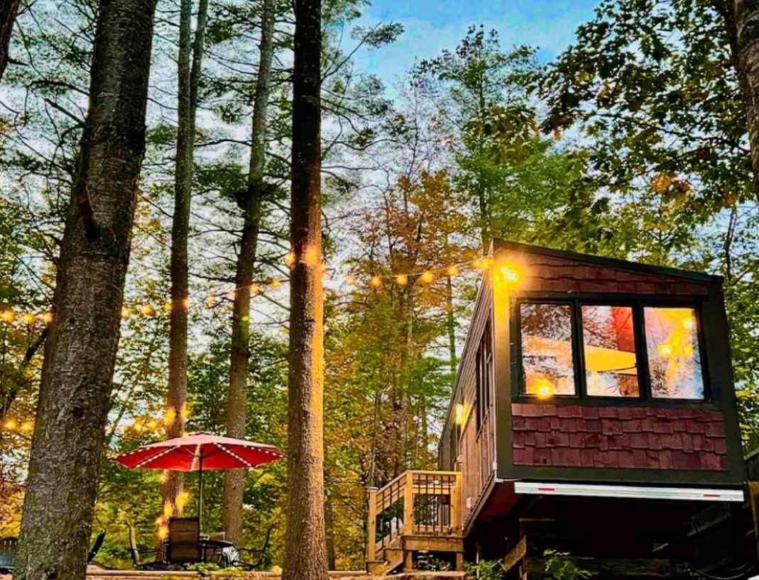 A view from the lake looking up at the tiny home. 