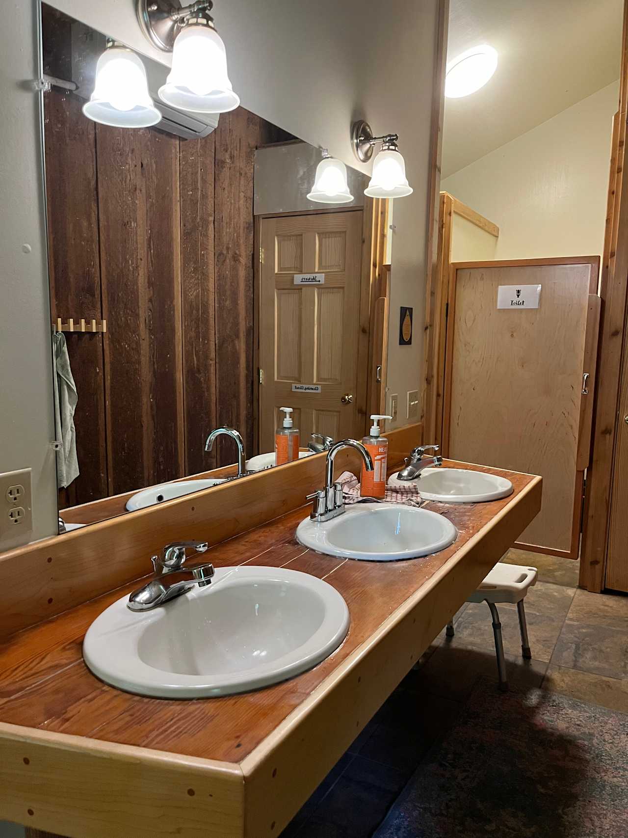 Toilet stalls with 2 showers and a community drying room. 