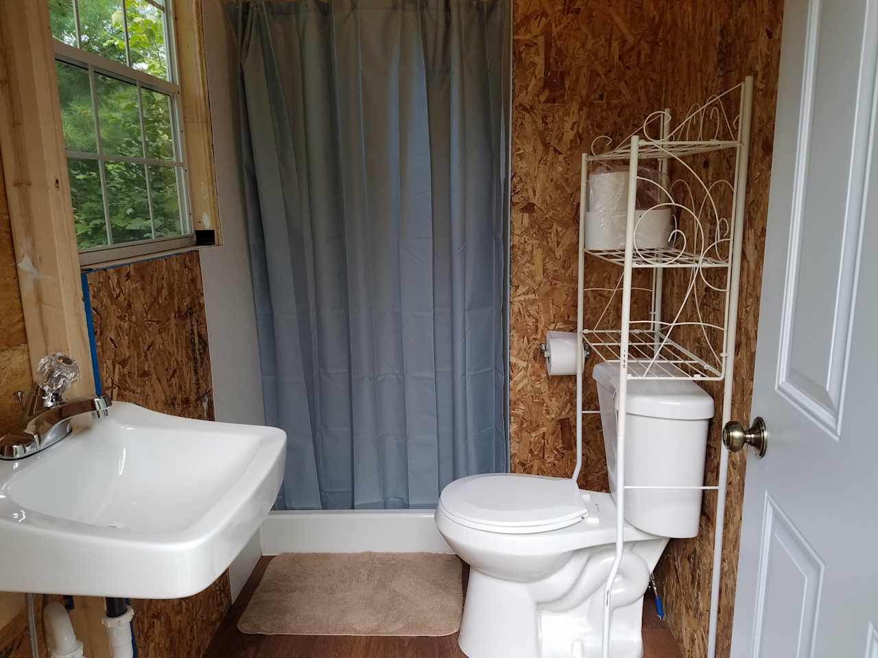 Private bathroom with standup shower, flushing toilet and sink