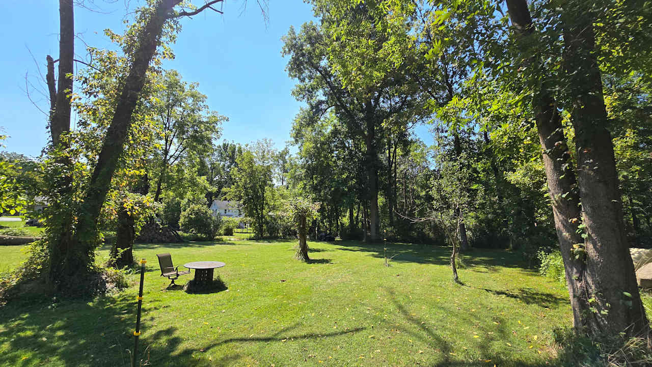 Site 4 for tents only.  40'x40' Set back with the most privacy. You can see the main house in the photo. There is a fire pit and table and chairs. 