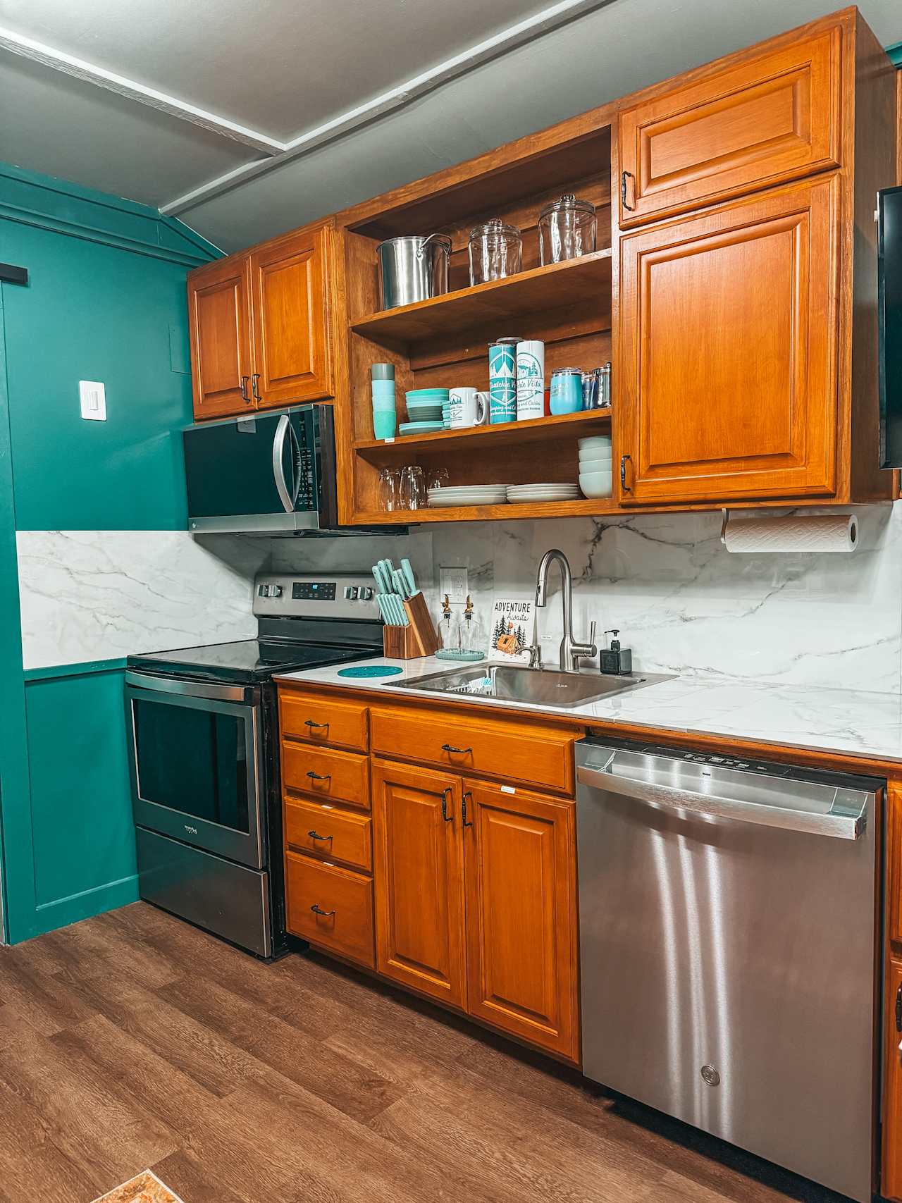 Full kitchen with flatware, servingware and appliances 