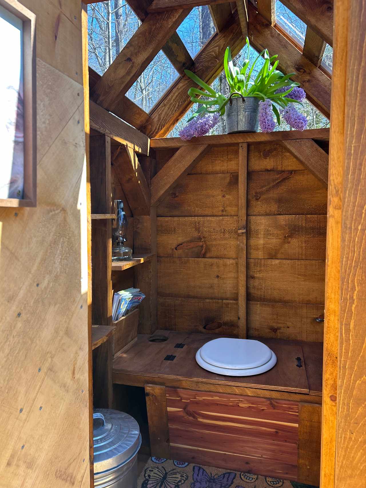 Enjoy our Jamaica Cottage Outhouse with a glass ceiling that brings the outside in. 