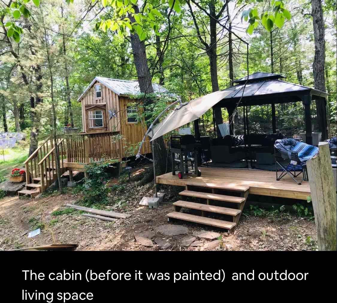 Cabin with outdoor kitchen & sitting areas. 