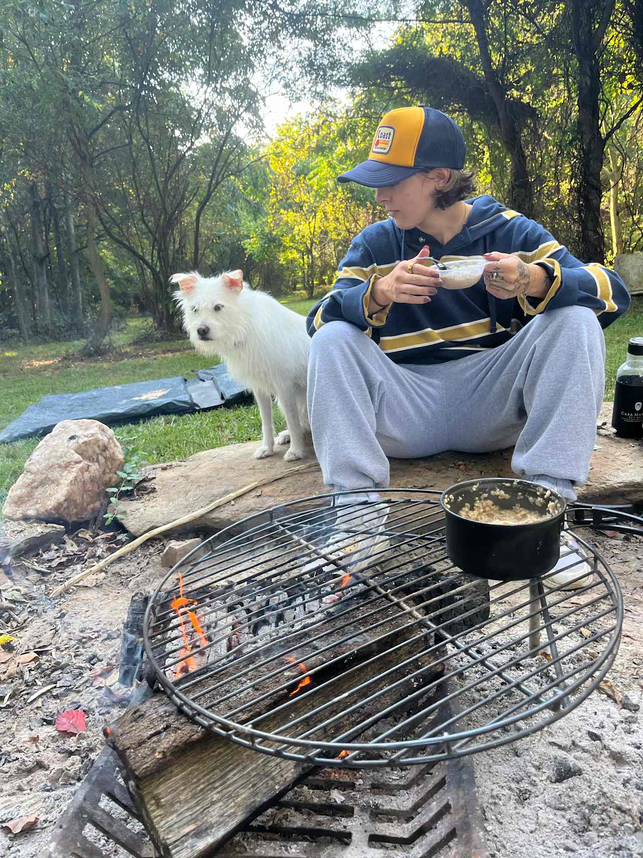 Large stone enclosed fire pit came with a (extremely helpful) little grate for a stove top! Fire pit also has metal holder thing for wood & a metal poker! 