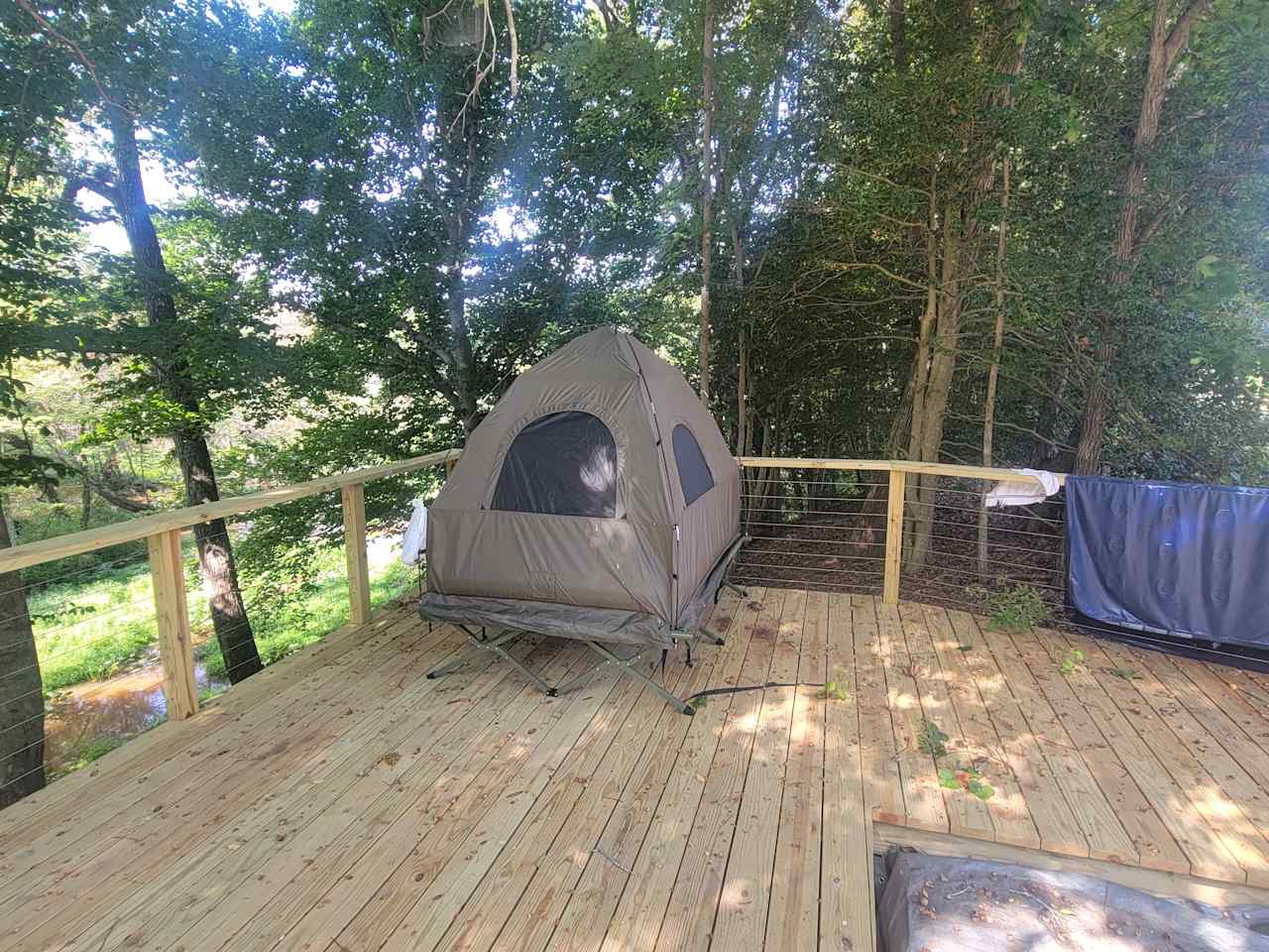 Tent is off ground and sleeps two.  Has a queen air mattress inside.  No toilet.  