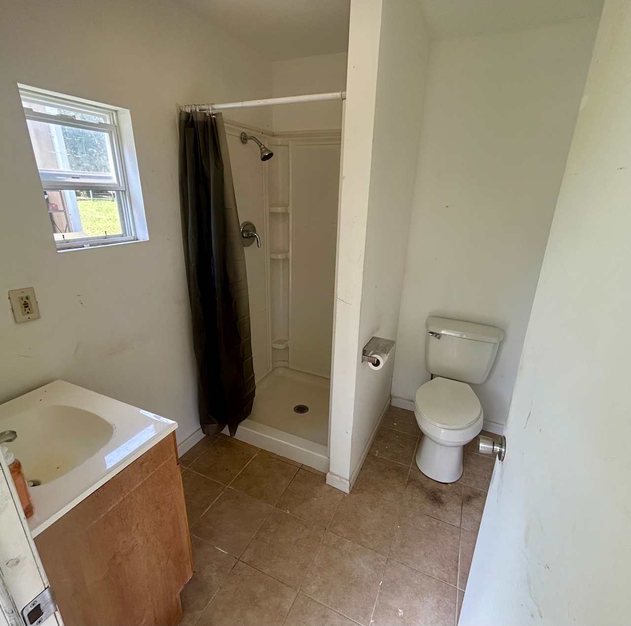 Full bathroom. There’s no air conditioning (hence the open window) but there is a full shower! Light and exhaust fan work, 1 bar of soap, hand soap, and toilet paper provided. (Trash can and over-toilet rack added but not pictured) Bring extra TP for large groups and your own shampoo/conditioner/body wash as desired. Will have blinds or curtain for privacy in window. 