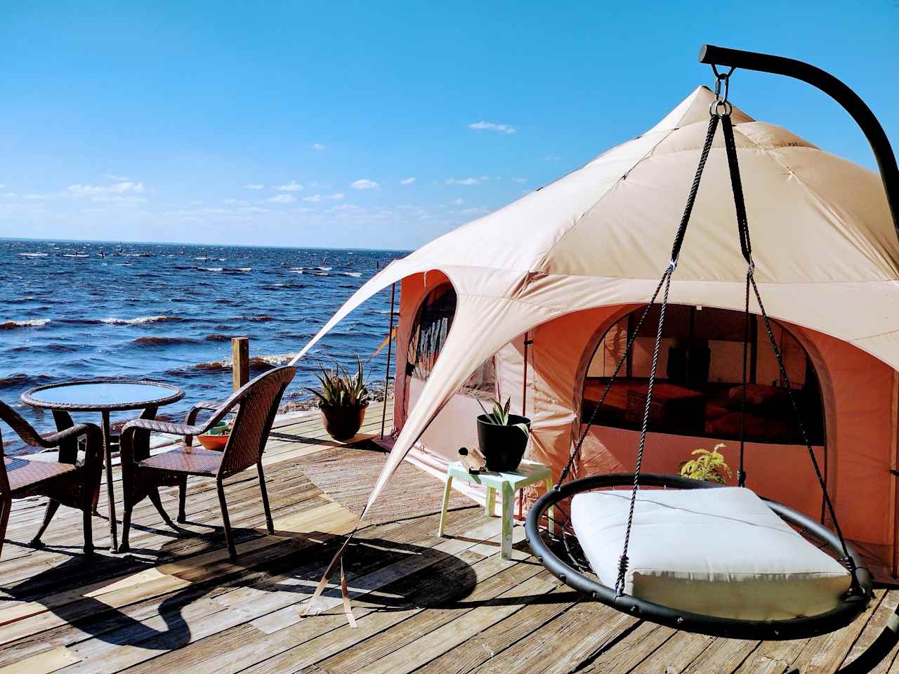 Romantic Waterfront Glamping Tent with room to relax and enjoy dreaming to the serene sounds of nature after a beautiful sunset evening. We are clothing optional so you can loose your tan lines and 420 friendly so you can loose your stress and Relax in Nature at Runaway Bay Lodge.