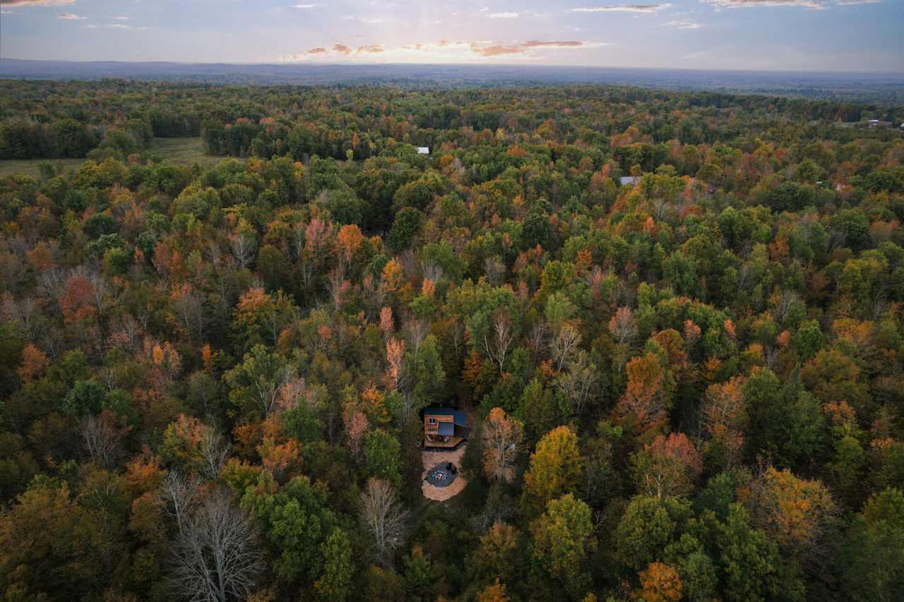 Early fall birds eye view of the property featuring Addys Cabin