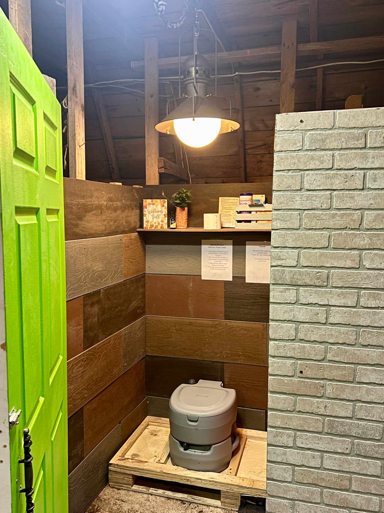 In-door bathroom with portable, flush toilet. 