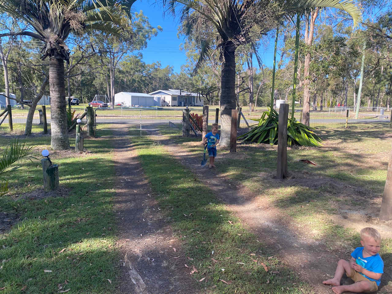 Front gate - our Little helpers building the new wooden fence for the site (to the right).