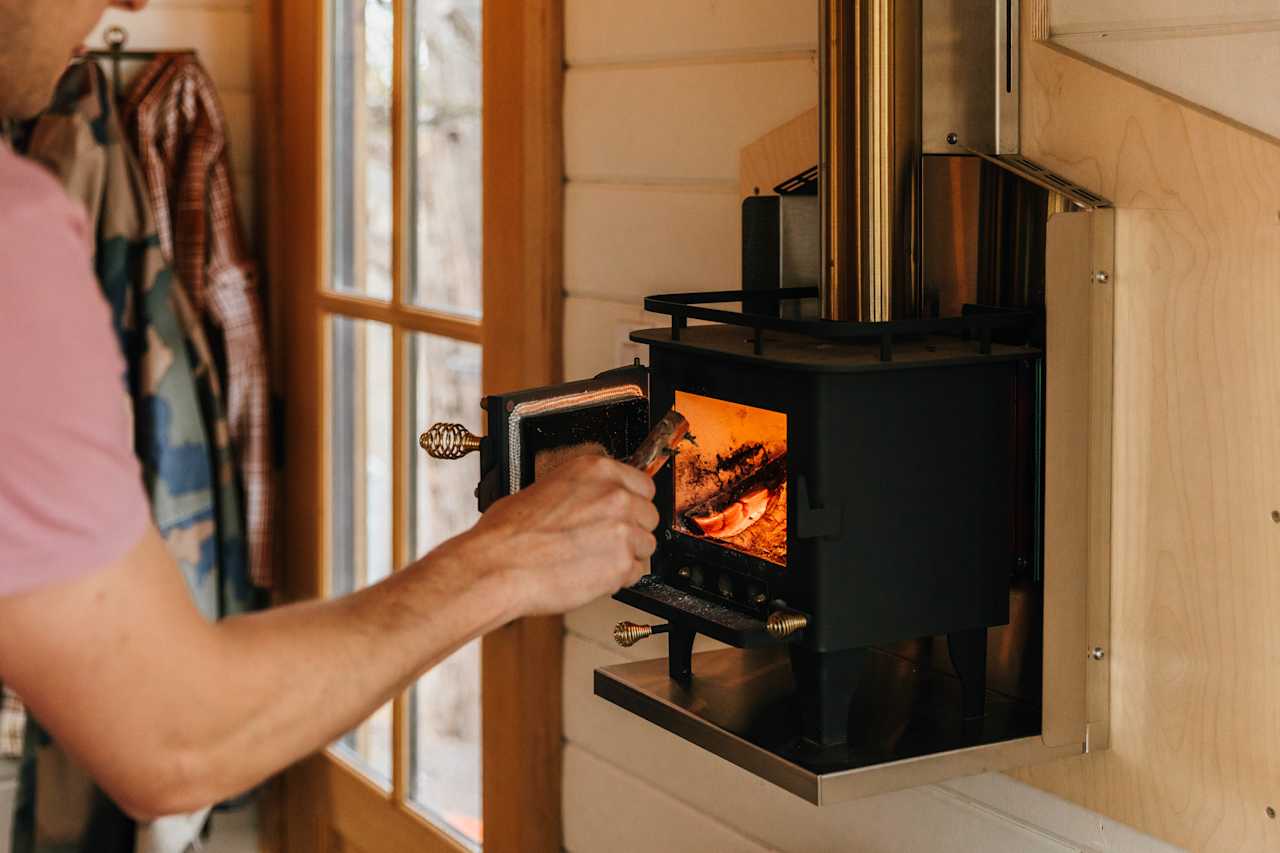 Enjoy a pellet fire in the tiny home to keep warm. Logs are provided.