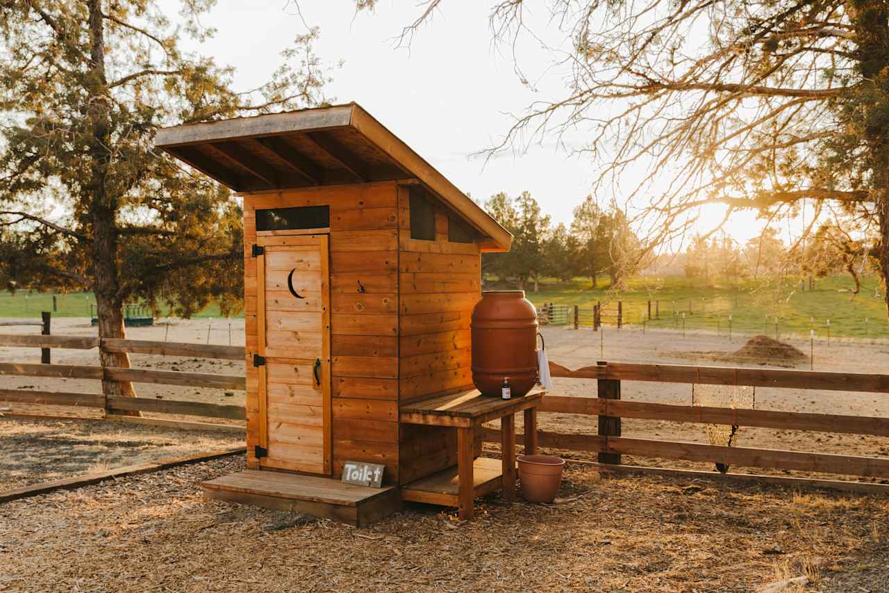 The bathroom is the same charming pit composting outhouse shared with the tent listing