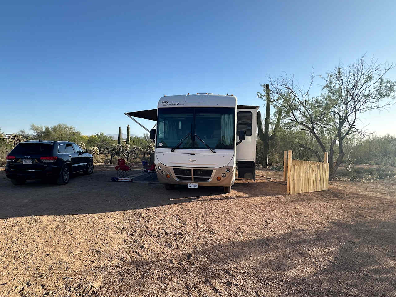 A 45 foot RV parked at site 2 with their vehicle parked in area to left of pad