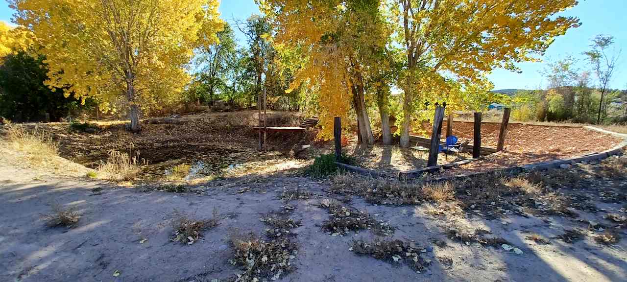 Ranch settiing landscaped with  a pond, swing and plenty of flat tent sites, running well water, electricity and 2 RV leveled pads with 30amp connecti