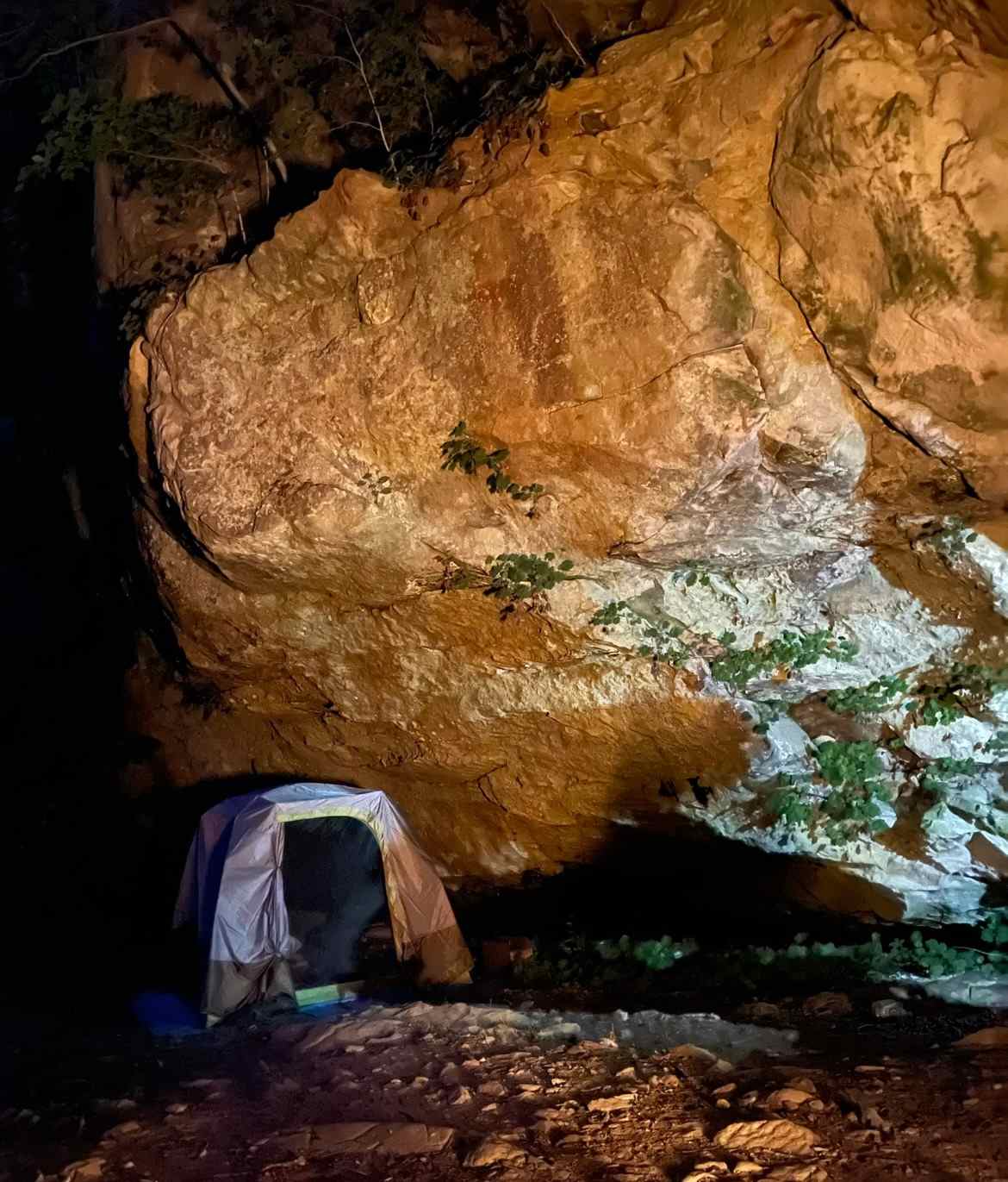 Tents under rock overhang.