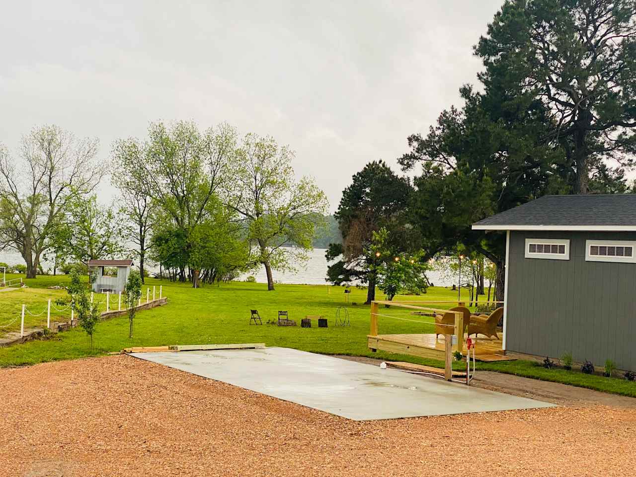 Concrete pad with Full Hook-Ups, Water/Sewer/Electric/Wi-Fi.
Beautiful view of Grand Lake. Over 1000 feet of shoreline. Fire Pit. Charcoal Grill. Occasionally access to the back deck of the vacation rental next door. 
