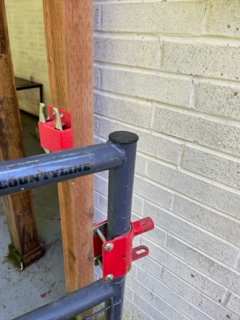 gate latch- pull **UP** not squeeze or pull forward on **ONE** of grey metal latches then swing forward or back gate depending on which latch you pulled up. this is very secure so your furry friend can play without leash