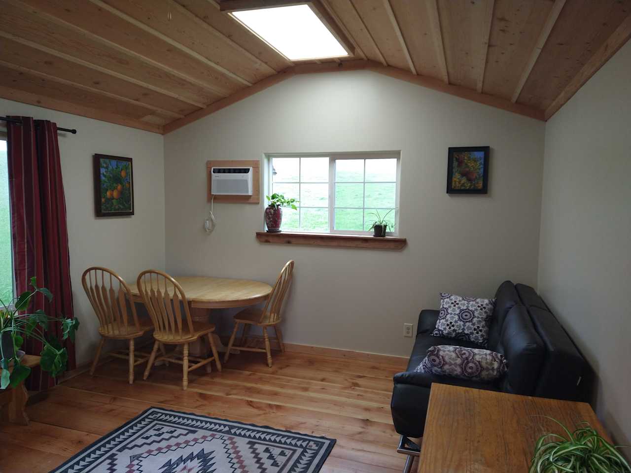 The 250 square foot cabin has an air conditioner for the summer months, a wood stove or electric heater for the winter months.
 The couch unfolds into a double bed.
