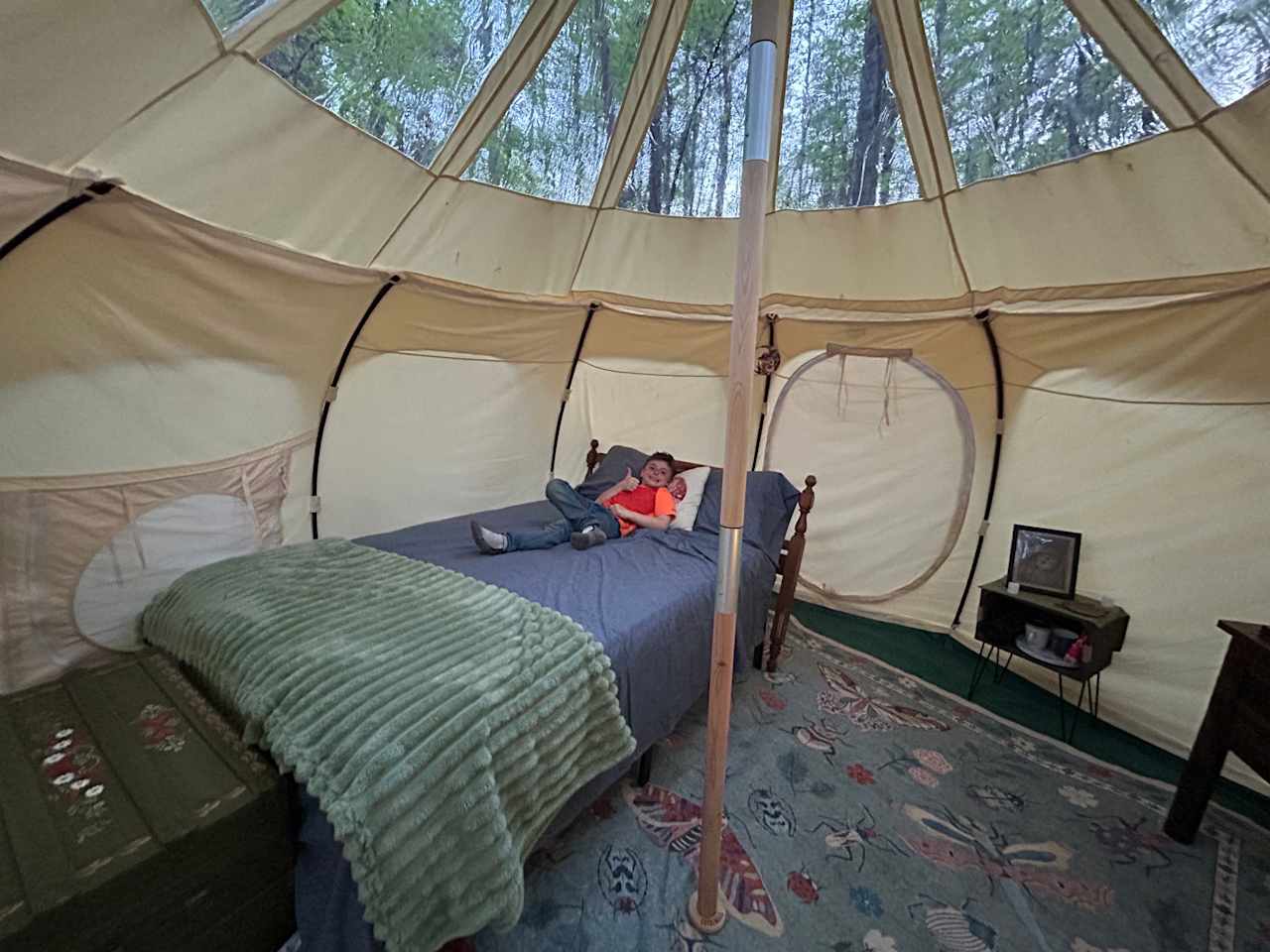 Spacious comfort awaits you with a full-size bed inside this lotus bell stargazer canvas yurt style tent