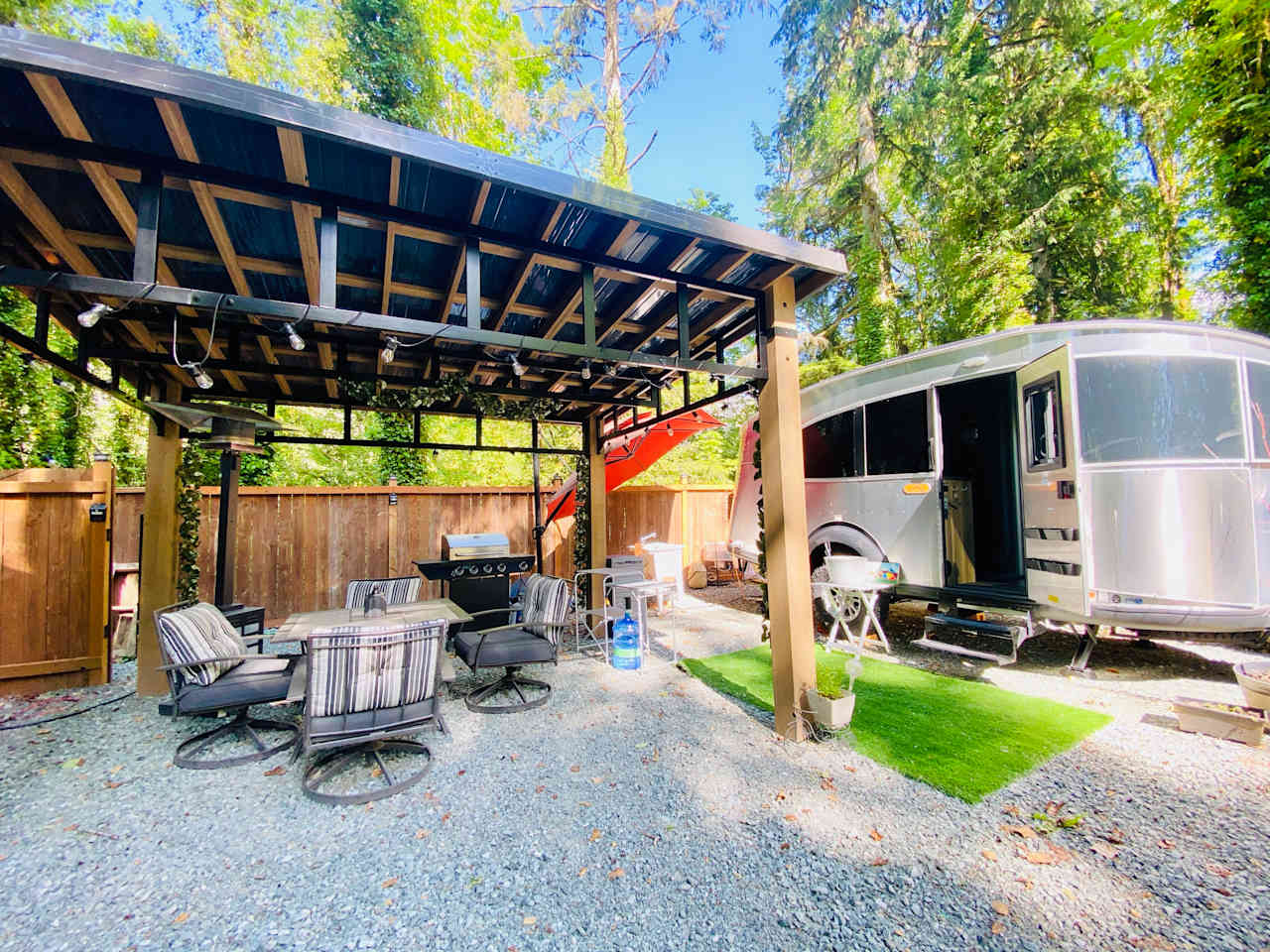 Outdoor kitchen area with a propane grill, wash sink, 10 gallon drinking water provided
