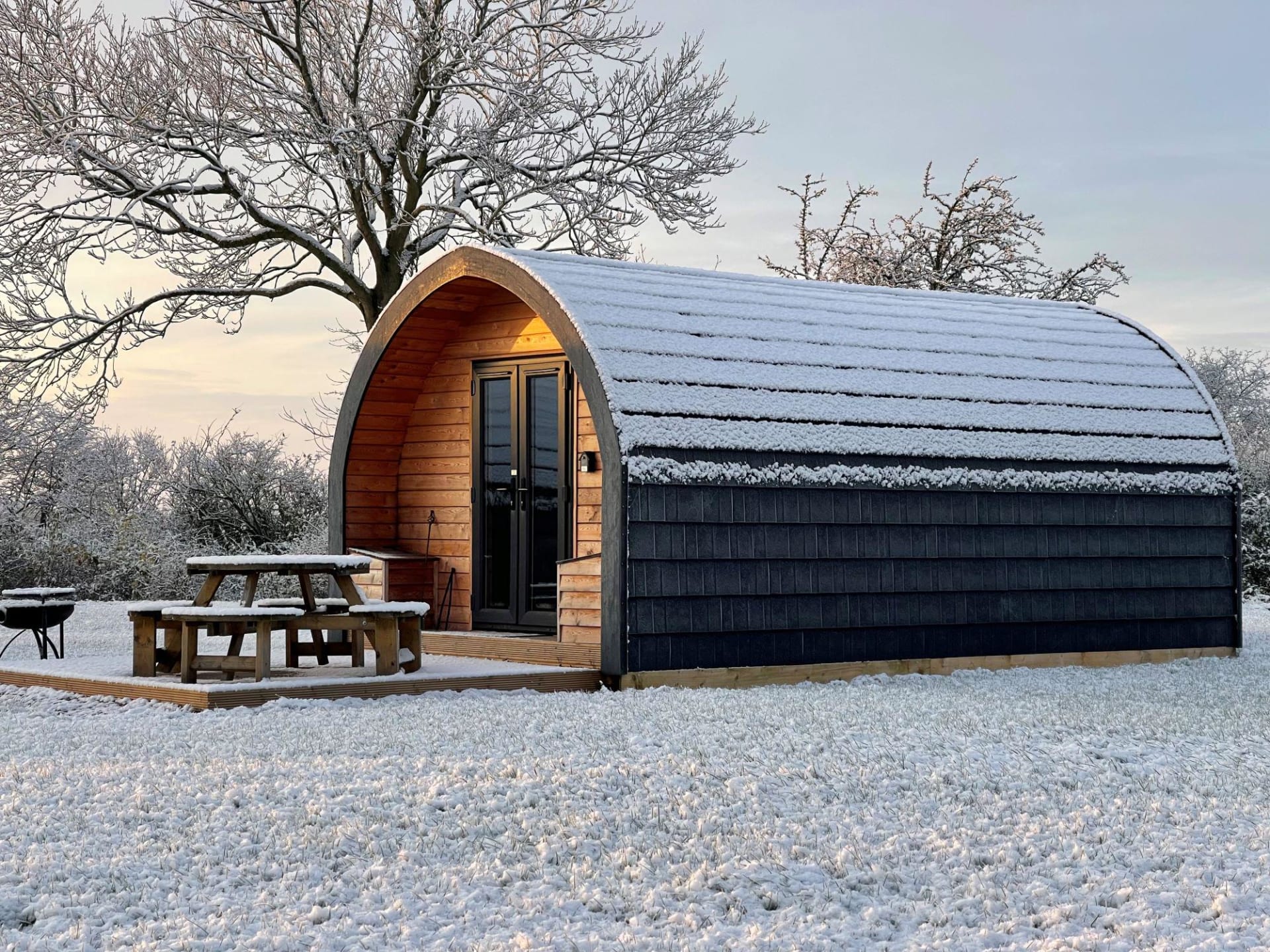 A snow-covered glamping pod