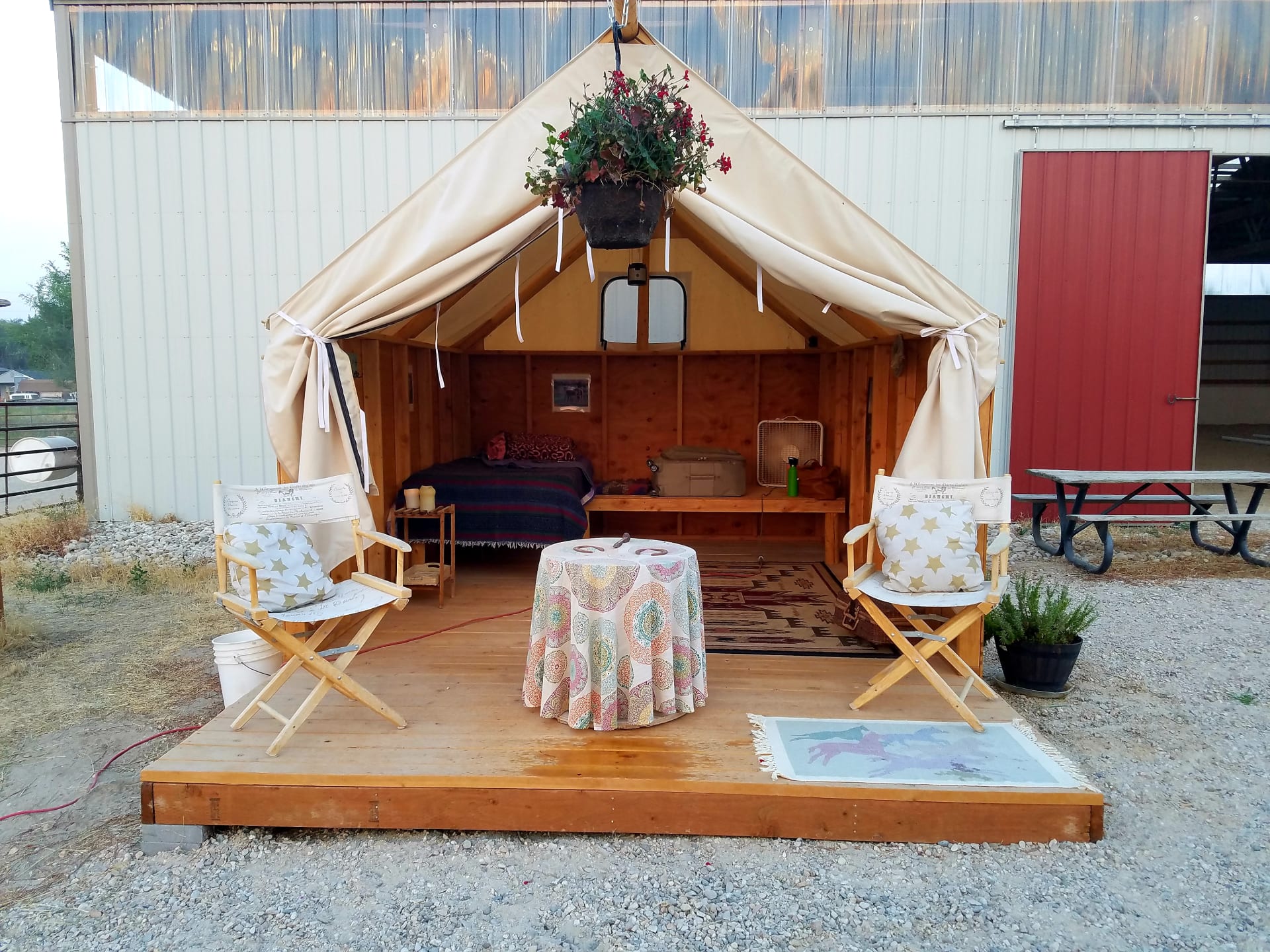 Our glamorous camping tent is cowgirl chic and fun! A custom-made wall tent is placed on a wooden platform with real wooden walls. Two single, comfy beds have linens and warm blankets. The whole tent is furnished with rustic ranch ambiance.