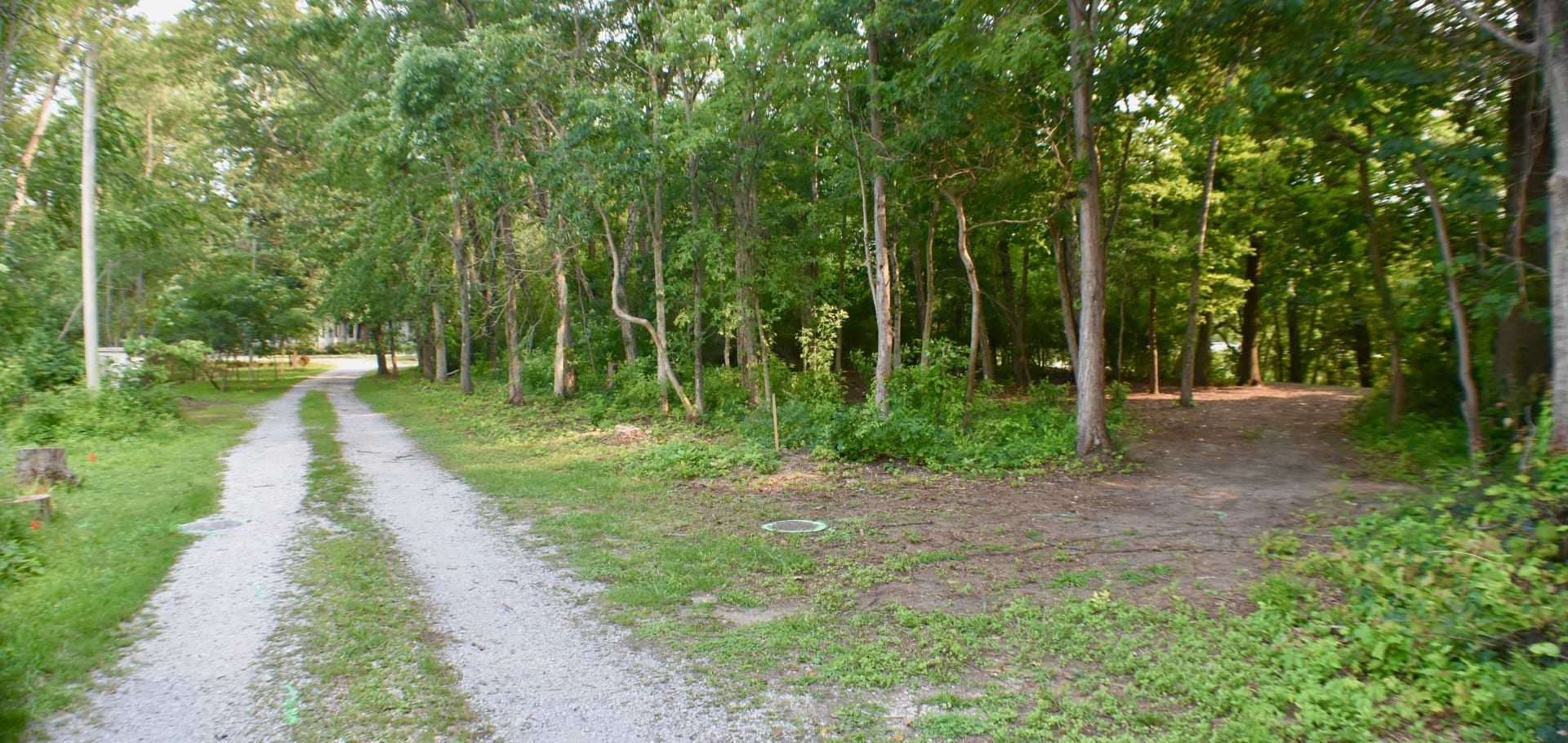 Entrance to Sunshine Acres with camp road to the right leading to camp areas.