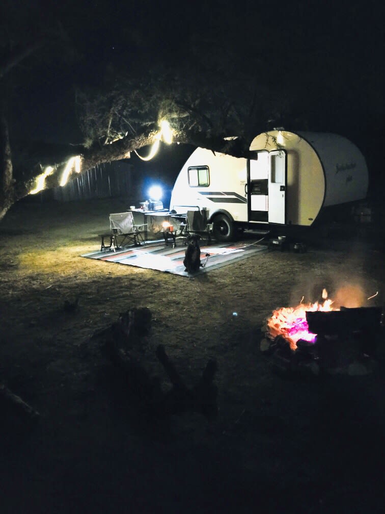 RV campers enjoying a warm fire on a starlit evening.