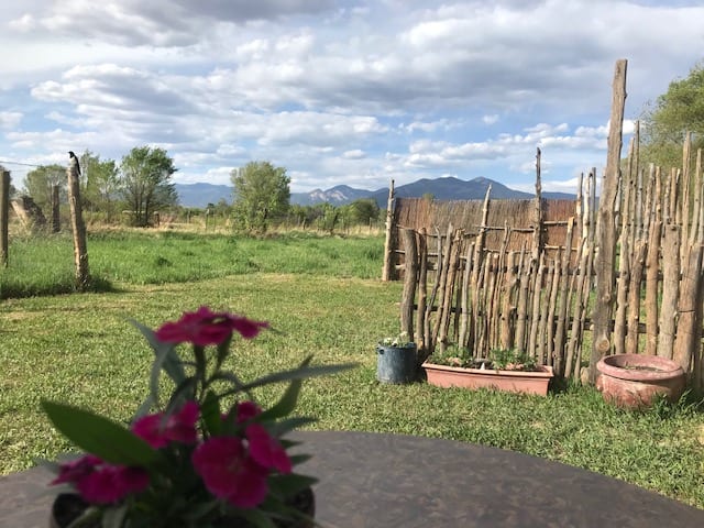 Sit by the trailer and view the majestic Taos Mountain and amazing sunsets. Campers and vehicles park between these two traditional latilla fences.