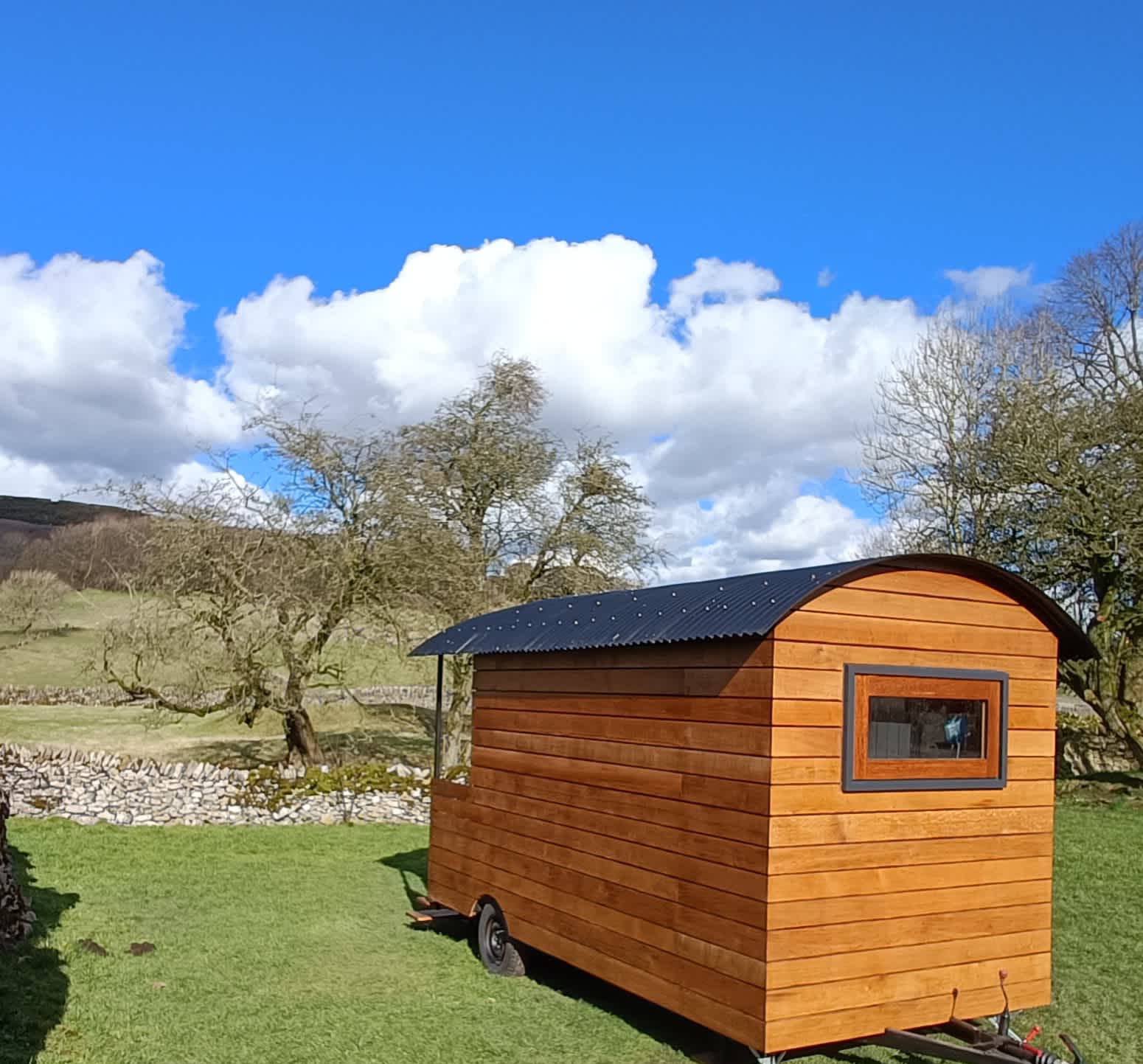 Rear view of the shepherds hut looking out at the stunning views 