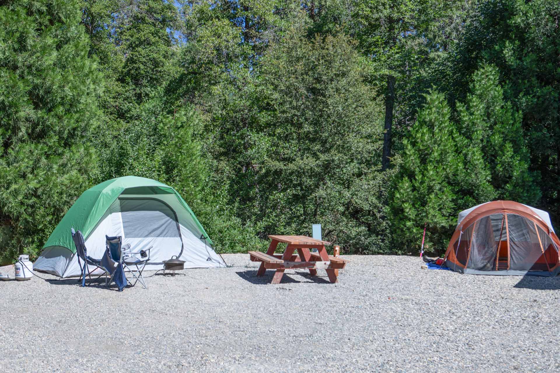 Pitch your tent on one of our spacious tent sites, each equipped with water and electricity for your convenience. You're just a short stroll from our refreshing pool, and the action of both the Adult Clubhouse and the Kids/Teen Clubhouse. Plus, a private trail entrance right by your site leads directly to the stunning shores of Bass Lake. With all this at your fingertips, your perfect outdoor adventure awaits!

Details:
- 1 tent per site.
- Maximum 6 guests per site.
- Water & electricity hookups available.